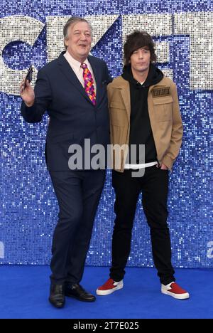 Stephen Fry and Elliott Spencer attend the 'Rocketman' UK premiere at Odeon Luxe Leicester Square in London. Stock Photo