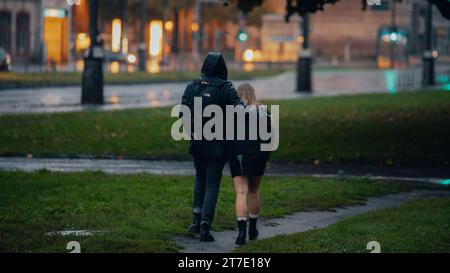 A young couple enjoying a romantic stroll in the rain Stock Photo