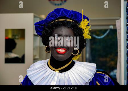 Black Piet / Zwarte Piet, portrait, is a controversial, Dutch figure, connected to Sinterklaas. Black Piet / Zwarte Piet assists, has a submissive role and, since he's (made) Black, a Discriminatory Symbol of Colonialism. This figure is protested against by the 'Kick Out Zwarte Piet'movement. Tilburg, Netherlands. Stock Photo