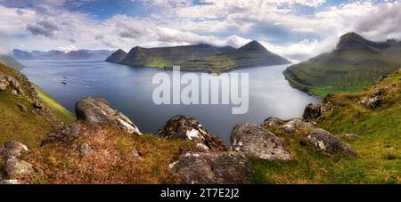 Panorama landscape of spectacular mountains and fjords near the village of Funningur from the Hvithamar mountain in Faroe Islands, Denmark. Stock Photo