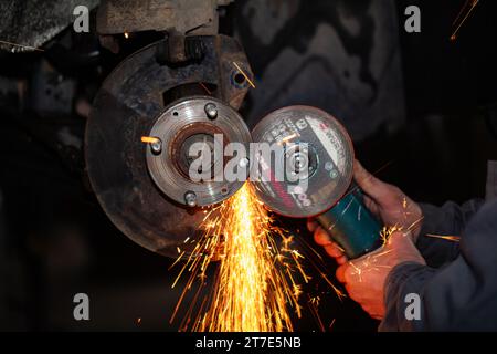 automobile wheel repair using angle grinder in car service Stock Photo