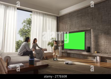 People are watching and enjoying next to the TV, monitor with green screen Stock Photo