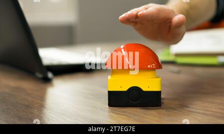 Hand reaches out to hit a buzzer in a office. Stock Photo