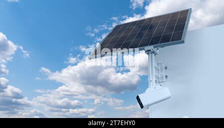 Autonomous surveillance camera with solar panel on a background of blue sky. Perimeter security. Stock Photo
