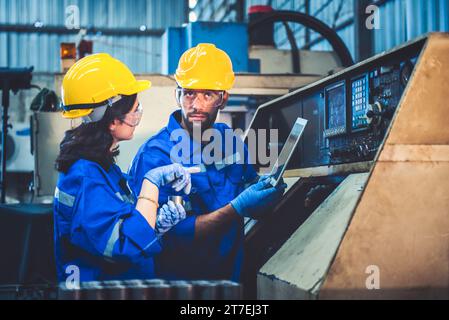Portrait of Heavy industry workers working on the metal fabrication process by operating a lathe at a machine for steel structure industry. Stock Photo