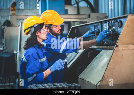 Portrait of Heavy industry workers working on the metal fabrication process by operating a lathe at a machine for steel structure industry. Stock Photo