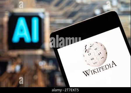China. 3rd Nov, 2023. In this photo illustration, the multilingual, web-based, free encyclopedia Wikipedia logo seen displayed on a smartphone with an Artificial intelligence (AI) chip and symbol in the background. (Credit Image: © Budrul Chukrut/SOPA Images via ZUMA Press Wire) EDITORIAL USAGE ONLY! Not for Commercial USAGE! Stock Photo