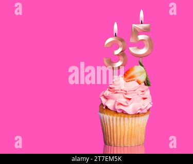 Birthday Cupcake With Candle Number 35 - On Hot Pink Background. Stock Photo