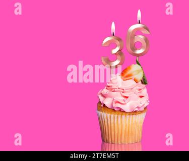 Birthday Cupcake With Candle Number 36 - On Hot Pink Background. Stock Photo