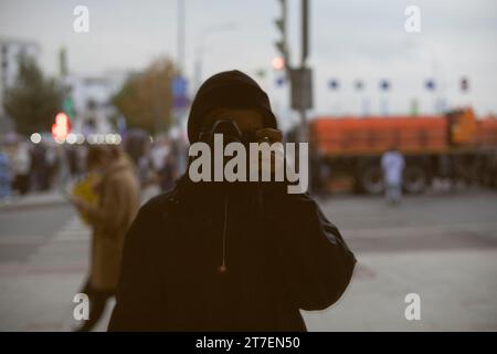 Photographer takes pictures of himself. Reflection in mirror. Reflection capture. Person with photo camera. Stock Photo