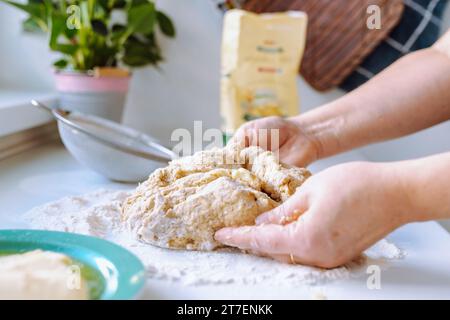 Female hands kneading dough Stock Photo