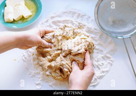 Female hands kneading dough Stock Photo