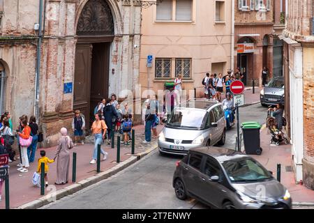Children and Teens being dropped off outside of school, Toulouse, France Stock Photo