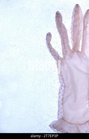 A single, ladies pink glove under water. Stock Photo