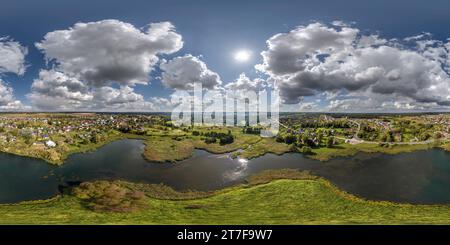 360 degree panoramic view of aerial full seamless spherical hdri 360 panorama view over the island and meandering river or lake with beautiful clouds in equirectangular projection