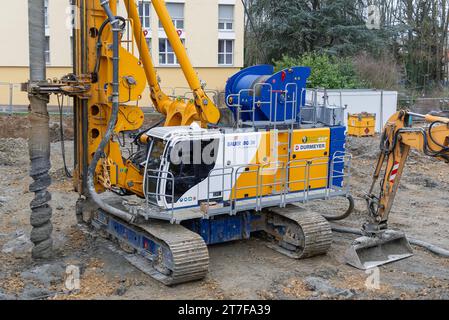 Metz, France - Yellow, white and blue drilling rig Bauer BG 36 on construction site. Stock Photo