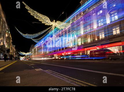 London, UK.  15 November 2023.  Traffic passes under the annual Christmas lights on Regent Street which have been switched on recently.   West End retailers are hoping for increased footfall during the festive season.   Credit: Stephen Chung / Alamy Live News Stock Photo
