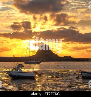 Sunrise in Summer over Lindisfarne Castle on the Holy Island of Lindisfarne In Northumberland as seen from the harbour Stock Photo