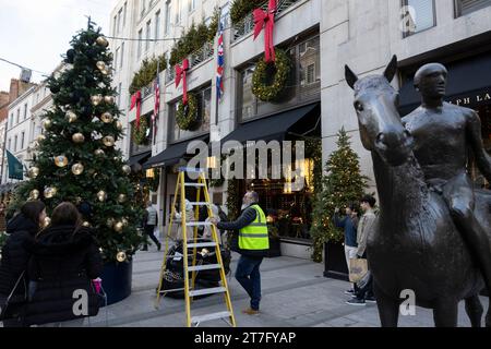 Christmas decorations are placed on a Xmas tree outside Ralph Lauren on Old Bond Street, Mayfair, London, England, United Kingdom. November 2023 Stock Photo