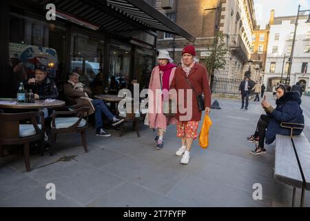 Ladies dressed in winter coats and hats walk past Cecconi's on Burlington Gardens in the heart of Mayfair, London, England, United Kingdom Stock Photo