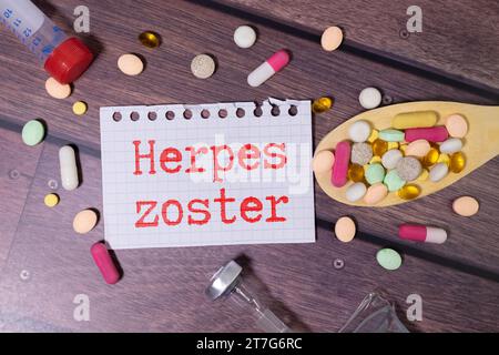 In the notebook text Herpes zoster, around laid out a lot of tablets Stock Photo
