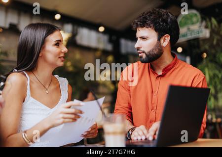 Architects and engineers discuss project planning, design, and costs. Collaboration and innovation fuel sustainable development in the workplace. Stock Photo