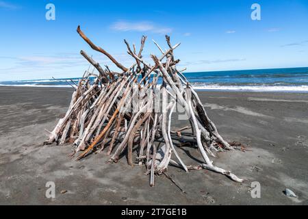 Hokitika beach is covered with driftwood and the locals enjoy building scultptures from the driftwooed. It is a historic town in New Zealand and renow Stock Photo