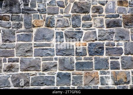 a chunky brick wall made from big blocks of stone Stock Photo