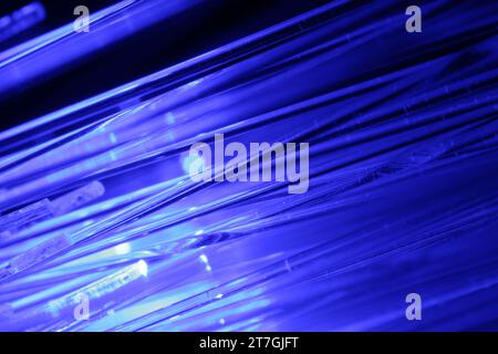 Optical fiber strands transmitting blue light, macro view Stock Photo