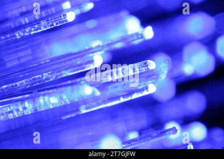 Optical fiber strands transmitting blue light, macro view Stock Photo