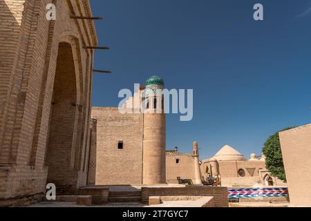 The Kutlimurodinok Madrasah next to Islam Hoja Minaret in the fortress Ichon-Qala, the old town of Khiva (Xiva), Uzbekistan. Stock Photo