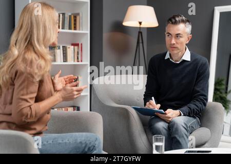 Mid shot woman talking man therapist Stock Photo