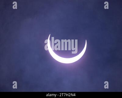 Evolving annular eclipse of the sun by the moon with thin clouds in the front of the sun. Photographed on October 14, 2023, in Beeville, Texas. Stock Photo