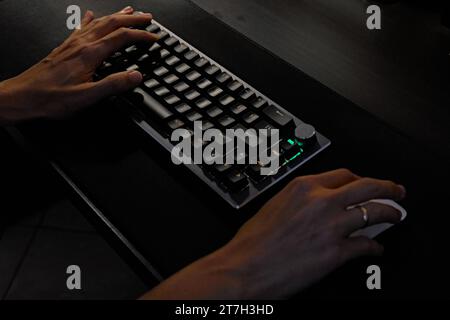 two hands typing on keyboard and operating mouse. Stock Photo