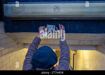 NEW YORK, NEW YORK - NOVEMBER 15: A Protester Plasters A "Zionism Is ...