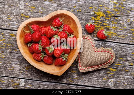 Strawberries in heart bowl - Valentine's Day. Flat lay Stock Photo