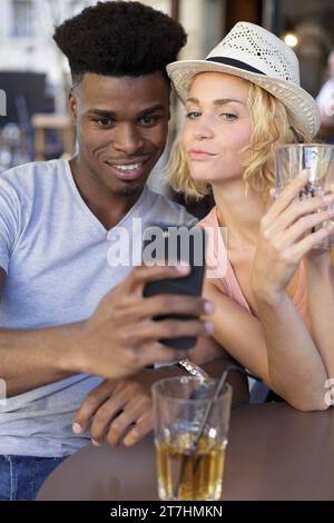 couple sitting in a cafe and taking a selfie Stock Photo