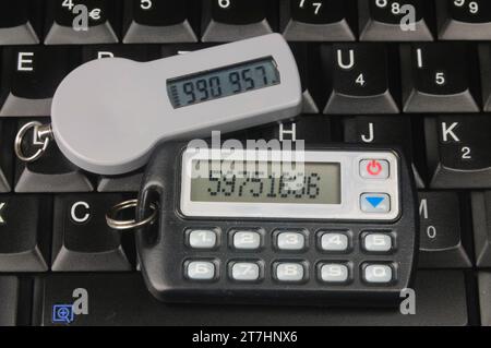 Two SecureID Tokens sitting on a computer keyboard Stock Photo