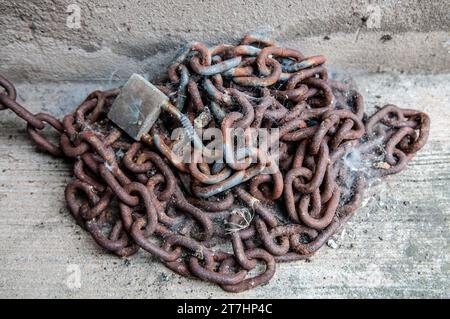 Rusty chain and lock covered with spiders' webs Stock Photo