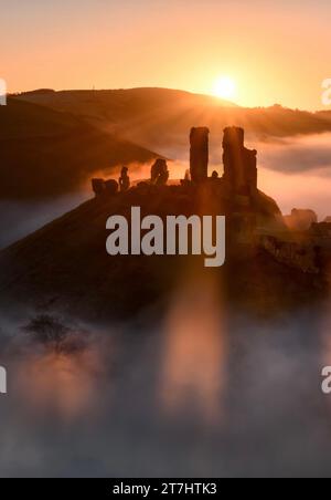 Corfe Castle in Dorset on a misty foggy morning at sunrise Stock Photo