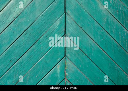 Barn door made of green painted wood. Rustic background. Stock Photo