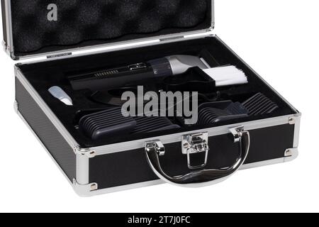 Closeup of a opened small black silver equipment case or suitcase with professional hairdresser's set isolated on a white background. Stock Photo