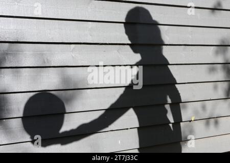 Teenage girl shadow of her holding volleyball Stock Photo