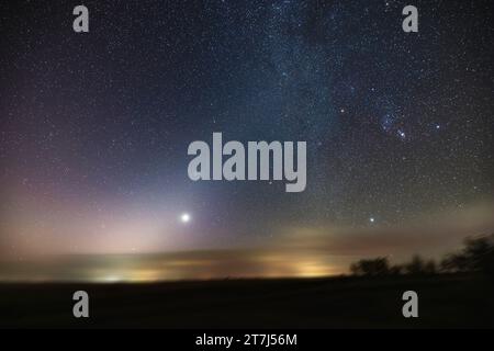 The morning Zodiacal Light (the subtle glow rising from the left up to top centre) with Venus as a morning star just below the Light.  The Zodiacal Li Stock Photo