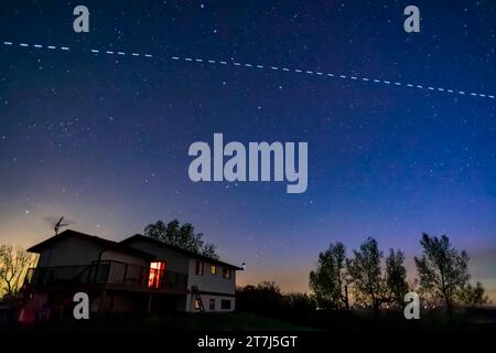 The passage of the SpaceX G2-9 Starlink group at about 3:30 am on May 15, 2023, with the satellite chain still bright five days after its May 10 launc Stock Photo