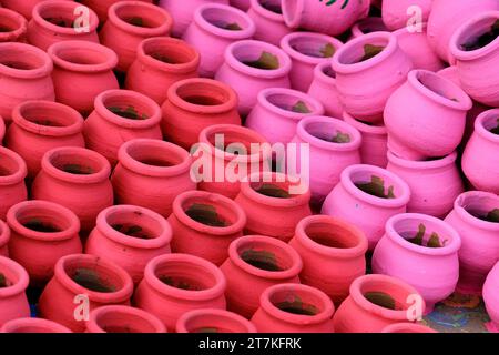03 November 2023, Pune, India, An Potter applies colour to earthenware oil pots or diyas at a workshop, ahead of the forthcoming Diwali festival, Stock Photo