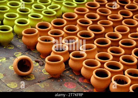 03 November 2023, Pune, India, An Potter applies colour to earthenware oil pots or diyas at a workshop, ahead of the forthcoming Diwali festival, Stock Photo
