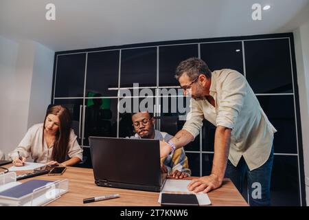 Diverse professionals in a modern boardroom collaborate, brainstorm, and develop project plans. Stock Photo