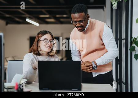 Diverse business professionals collaborating on strategic planning and market research for sustainability and profit growth. Stock Photo