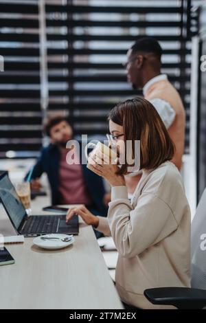 Business Group Collaborating on Strategic Planning and Market Analysis in Corporate Office Stock Photo